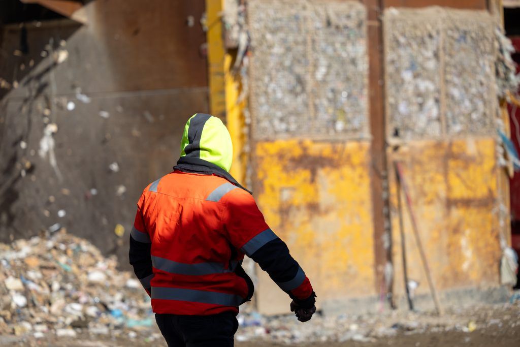 Man in a waste disposal transfer station